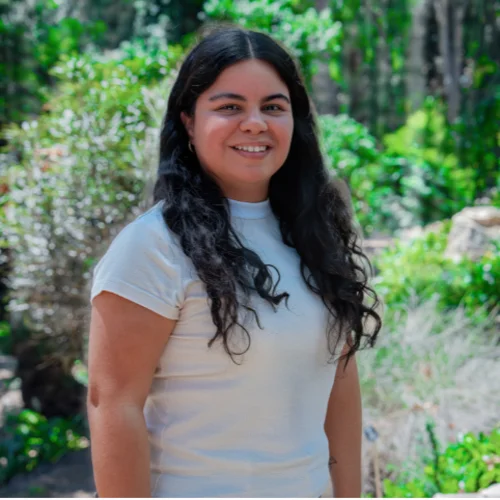 Headshot of Sofia Machuca smiling with trees in background