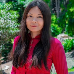 Headshot of Mirava Yuson smiling with nature background