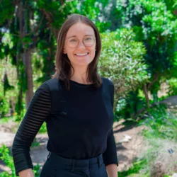 Headshot of Nicole Stephan smiling with trees in background